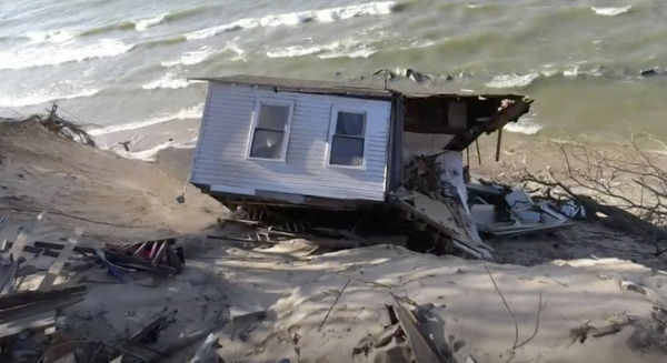 House falls off bluff to Lake Michigan shore